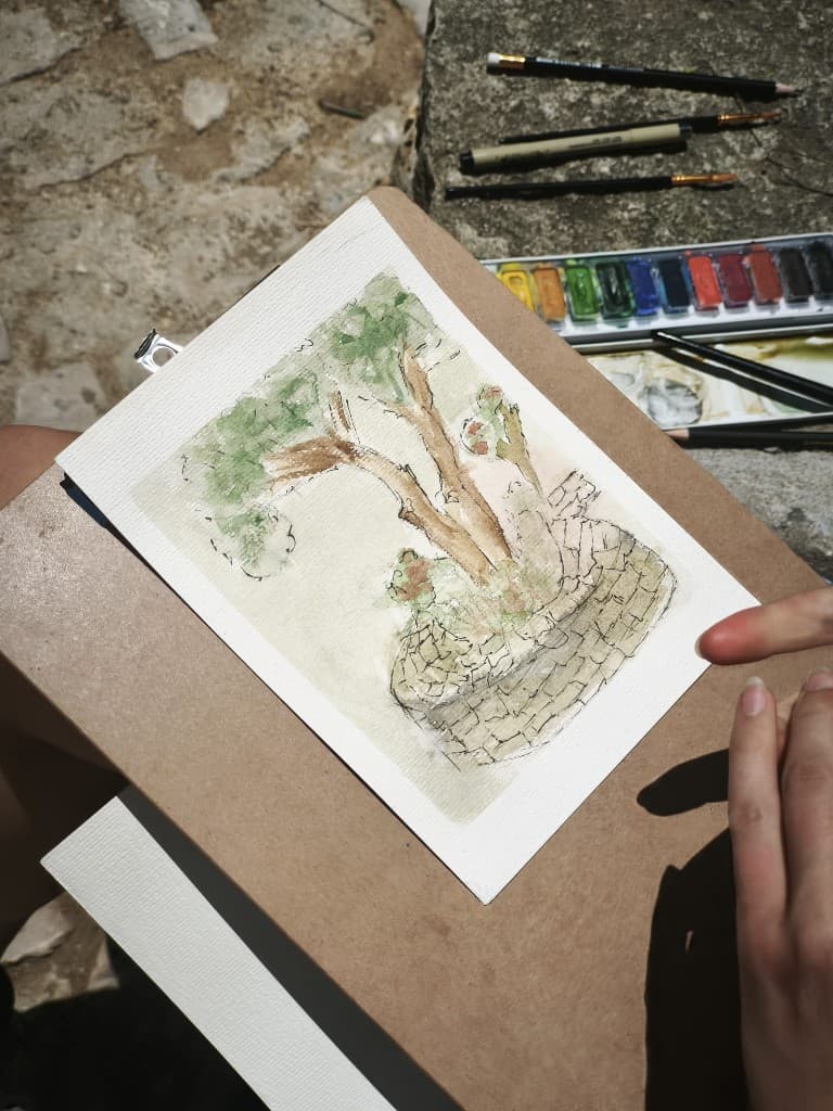 Watercolor sketch of a tree on a stone wall